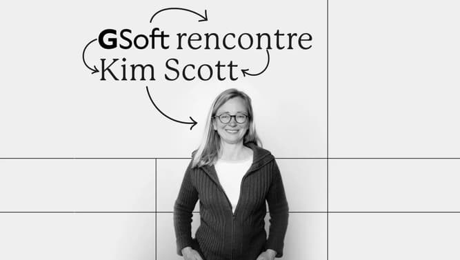 Kim Scott standing in front of a sign that reads 'Kim Scott Meeting Gsoft'
